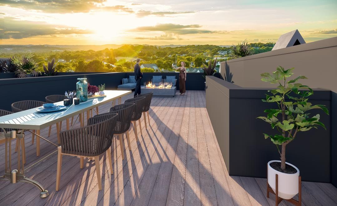 a deck with a table and chairs and a view of a sunset